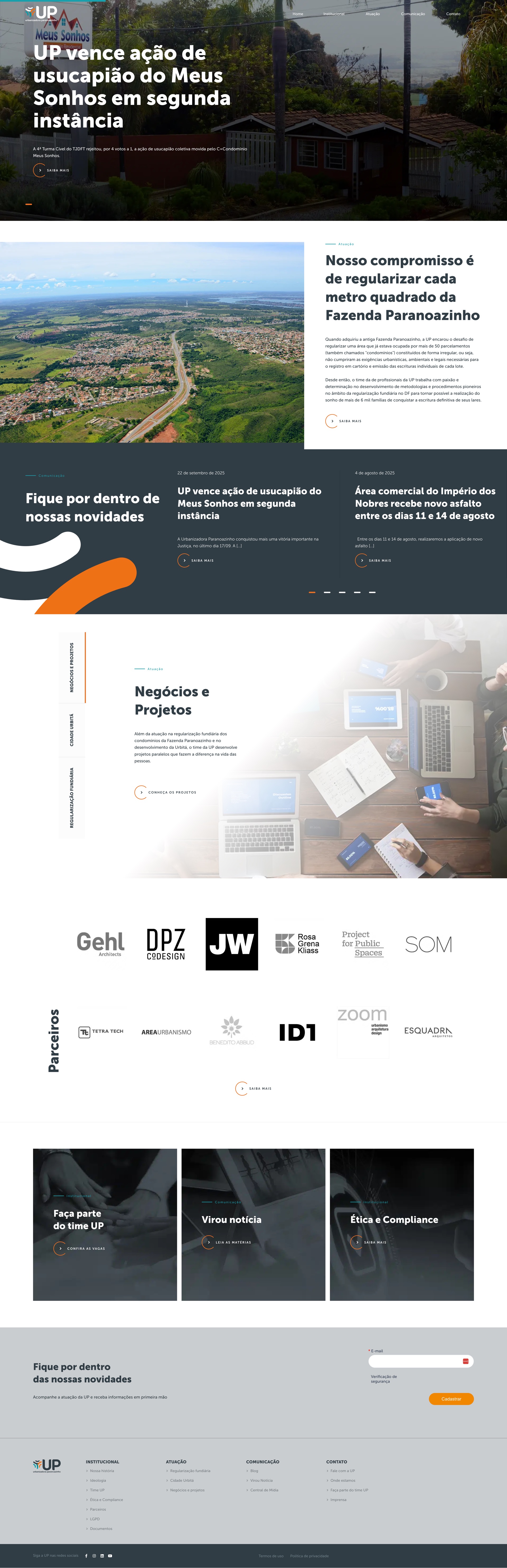 Homepage: a news-led hero announcing UP's win in the Meus Sonhos usucapião appeal, the Nosso compromisso aerial of the Fazenda Paranoazinho, the dark news rail with the orange swoosh, the Parceiros grid (Gehl, DPZ, SOM and more), and the newsletter signup